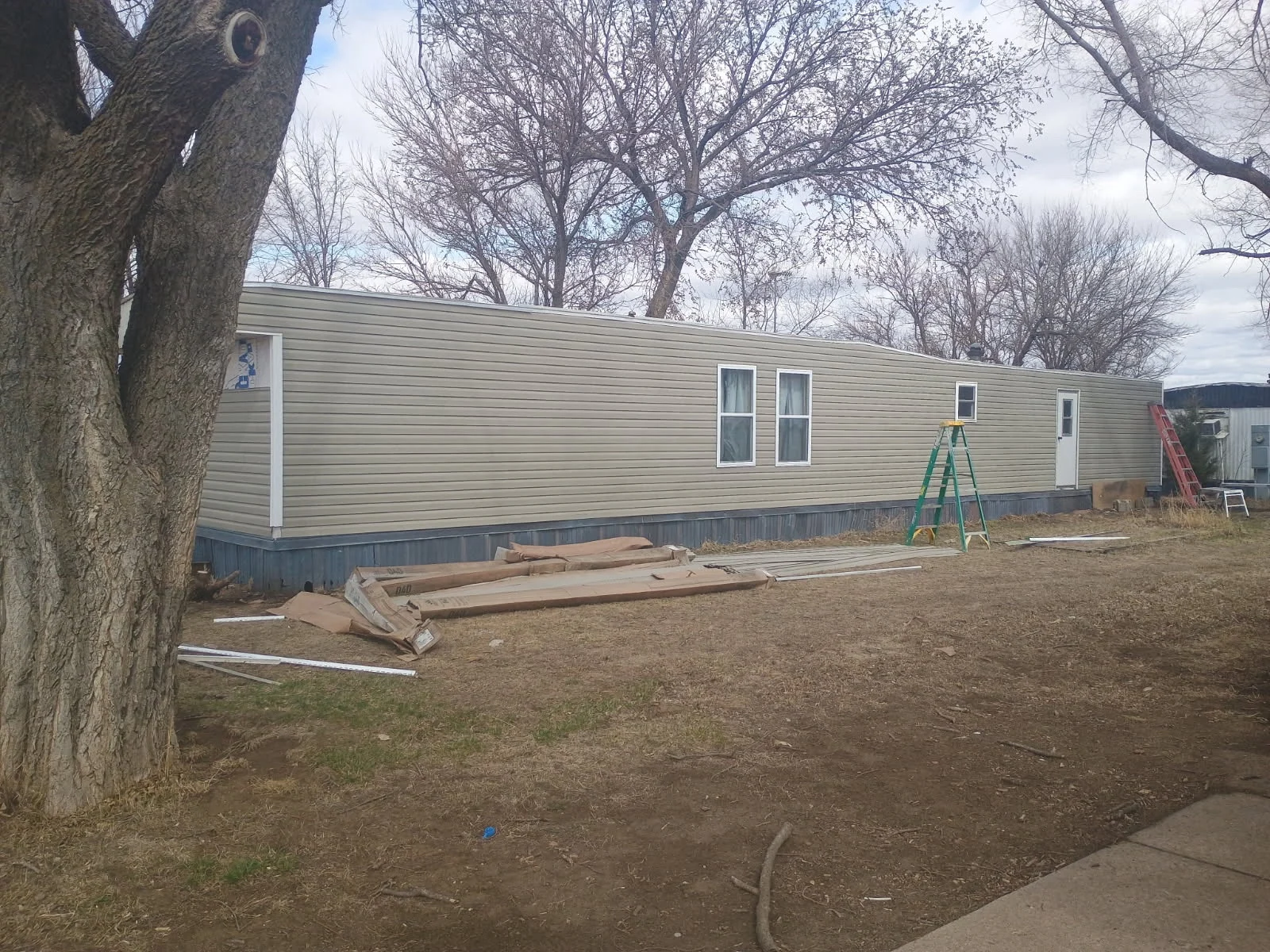 A second view of the same mobile-home siding and window project.